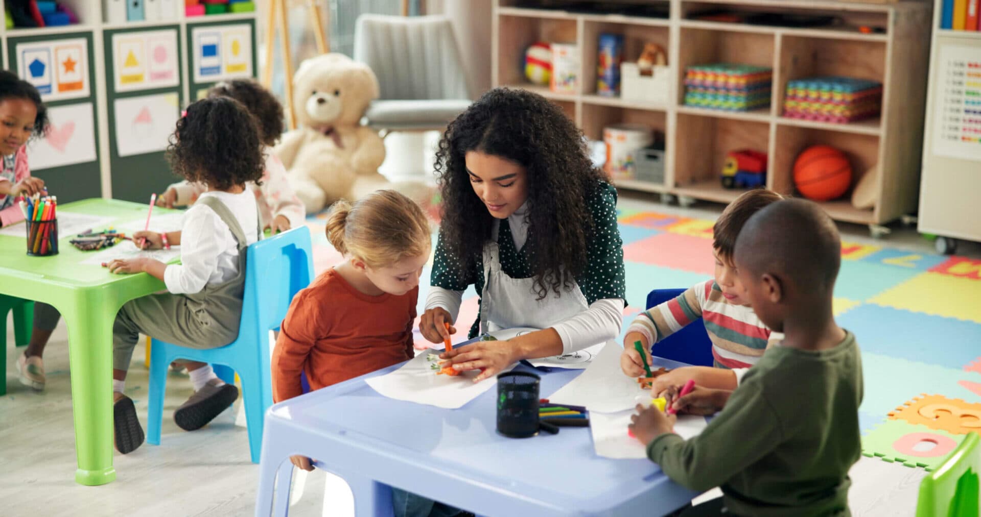 A Creative Playrooms teacher working with children