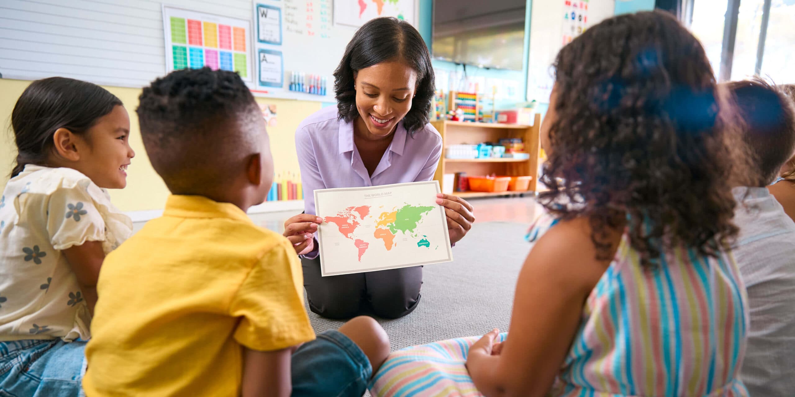 A teacher leading a geography lesson at Creative Playrooms Maple Heights